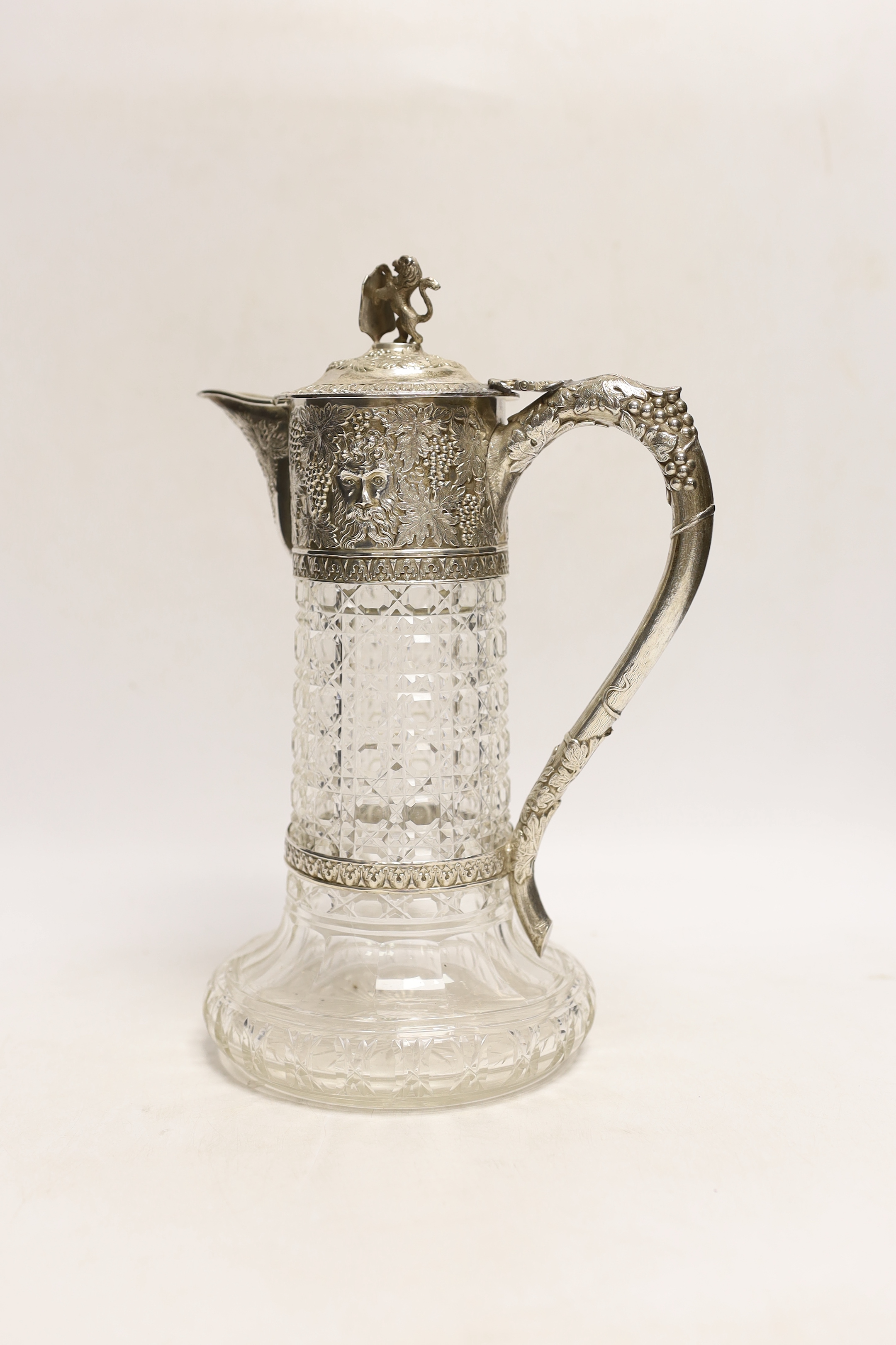 A late Victorian silver mounted cut glass claret jug, by Charles Boyton, London, 1899, the mount with fruiting vine and mask decoration, 27.5cm.